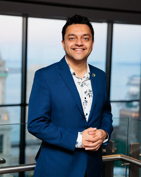Parth Pandya, founder of Akshar Technologies, smiling in a blue jacket.
